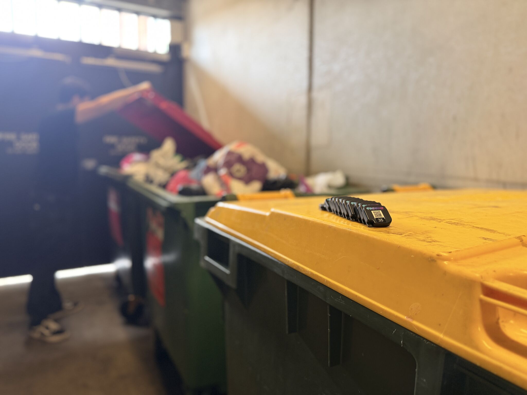 Shrunk tracking tags on a bin lid during a waste audit