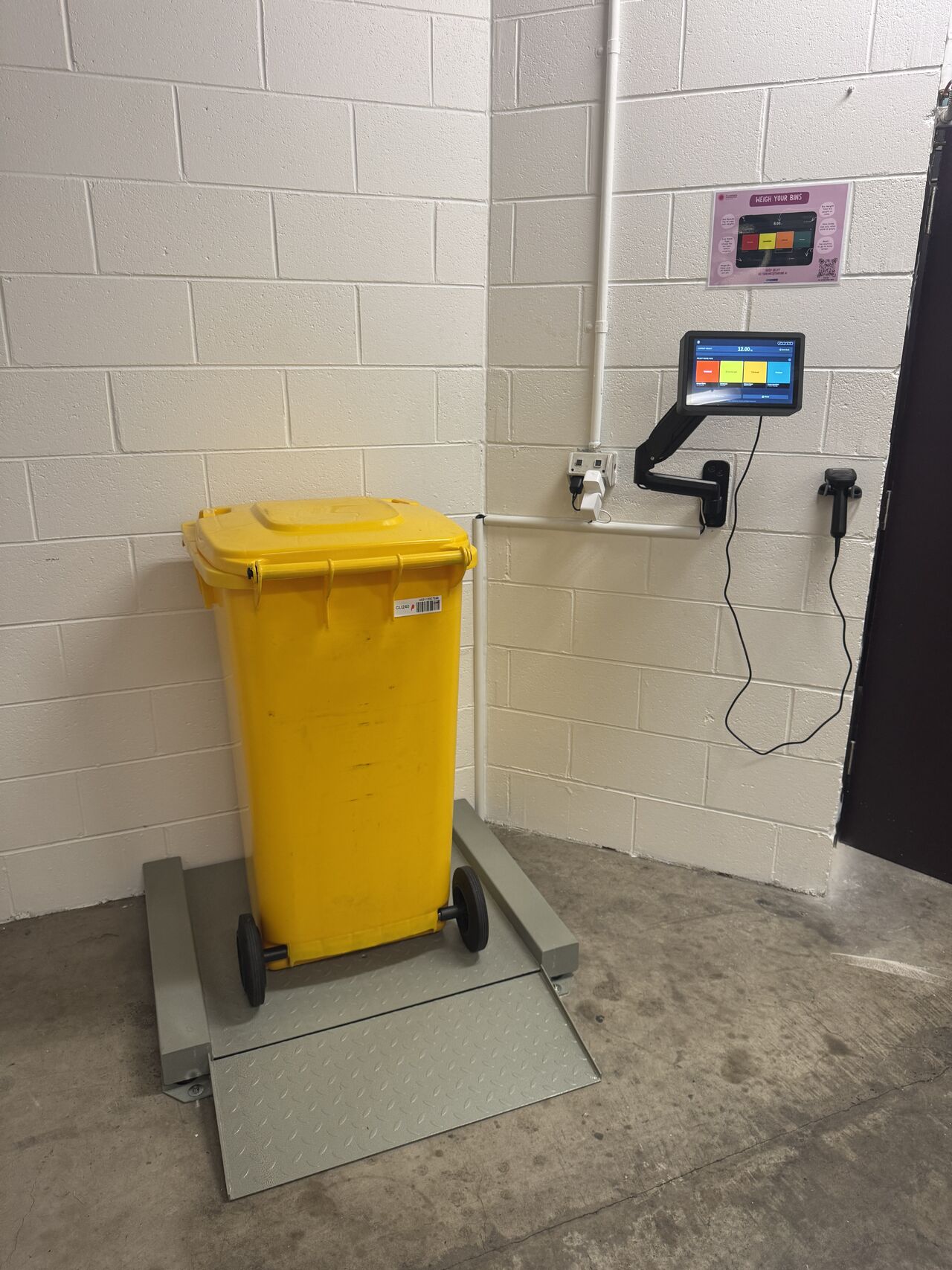 Shrunk bin scale and touchscreen deployed in a waste room